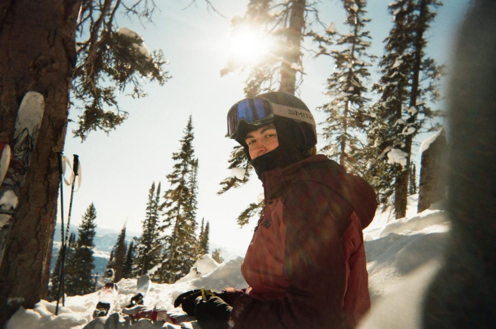 Noah sitting among snow-covered trees on a ski mountain